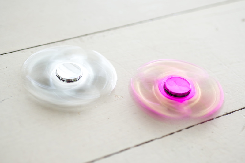 indoors, movement, Spinner, play, pink color, close-up, rotation, Fidget, fidget spinner, autism, flooring, glass - material, various fidget spinner, roll