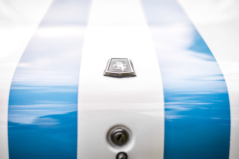 badge, vehicle, close-up, air vehicle, white color, reflection, tucuman, car, hubcap, automobile, full frame, day, emblem, sphere, jaguar car, outdoors