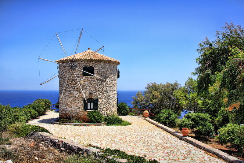 environmental conservation, turbine, tree, building exterior, wind turbine, greek island, ocean, surround, sea, outdoors, daytime, building, architecture