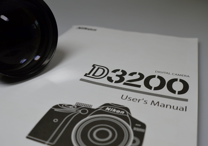 manual, western script, close-up, copy space, creativity, black color, high angle view, camera, text, table, still life, d3200, arts culture and entertainment