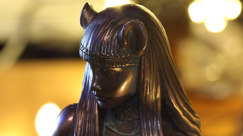 cat goddess, focus on foreground, gold colored, sculpture, single object, idol, statue, representation, close-up, male likeness, religion, belief, bastet