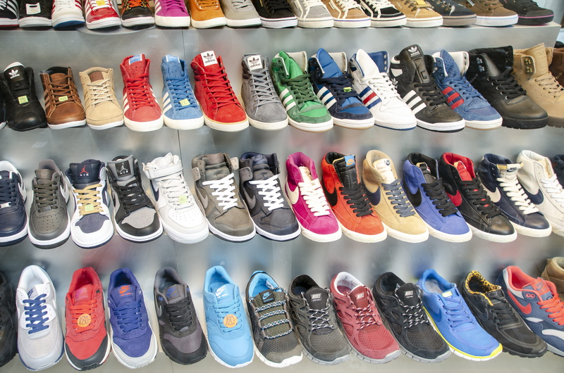large group of objects, colorful, indoors, shoes, order, abundance, blue, consumerism, shoe shop, sneaker, sneakers, display, footwear, clothing, arrangement