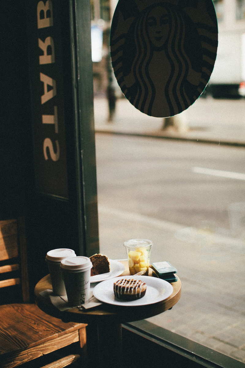 text, refreshment, freshness, blur, delicious, wood, coffee - drink, coffee shop, starbucks, drinks, city, furniture, no people, glass - material, wooden