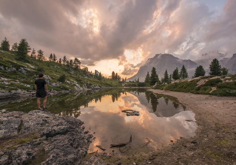 leisure activity, non-urban scene, sunset, rear view, scenics, adventure, mountain, stands, river, clouds, real people, tranquil scene, rock, scenics - nature