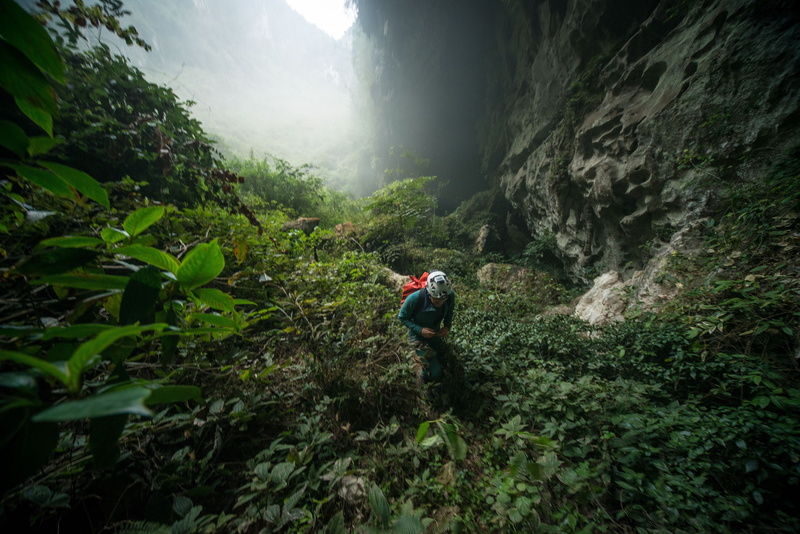 beauty in nature, white, hiking, cave, lifestyles, 4K, one person, land, scenics - nature, forest, nature, plant, shirt, real people, black, s, backpack