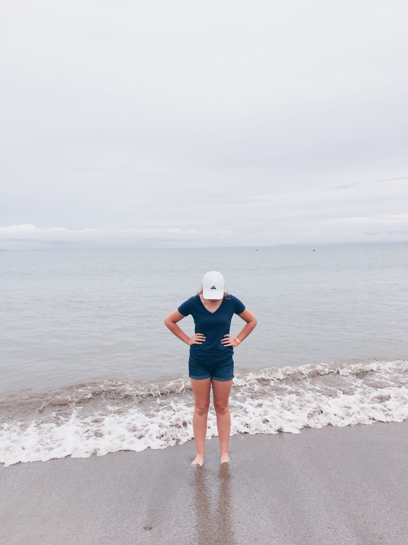 beach, casual clothing, simple, outdoors, teenager, beauty in nature, hat, shirt, clouds, nature, standing, sea shore, simplicity, leisure activity, one person