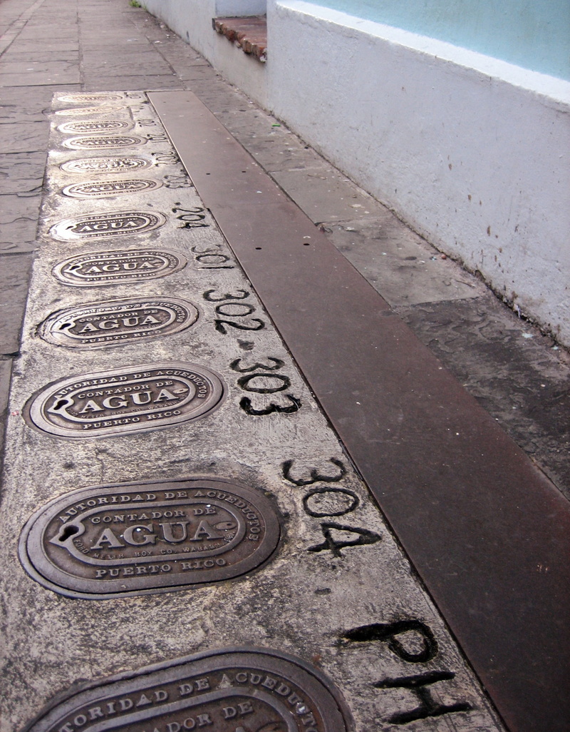 road, no people, text, communication, puerto, day, western script, in a row, sidewalk, close-up, pattern, street detail, street, water, water main, manhole