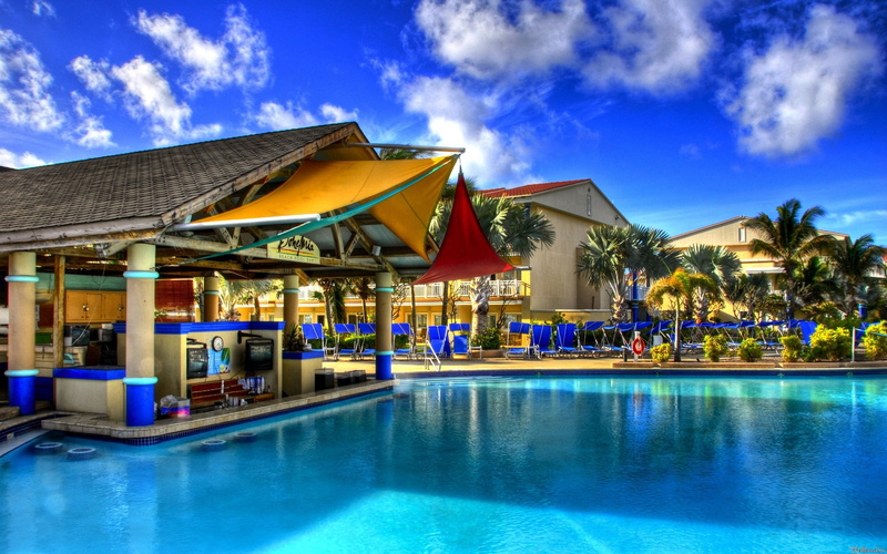 furniture, tropical Climate, sea, green, lounge chair, building Exterior, pool, vacations, wealth, home, reflection, luxury, bar - Drink Establishment