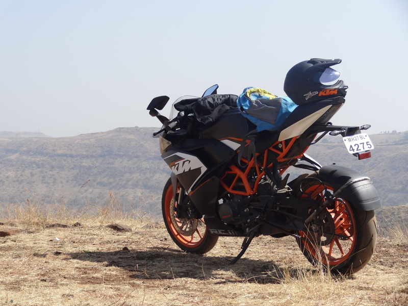 stationary, mountain, helmet, bike, clear sky, land, crash helmet, biker, land vehicle, riding, sunlight, environment, outdoors, nature, landscape, motorcycle