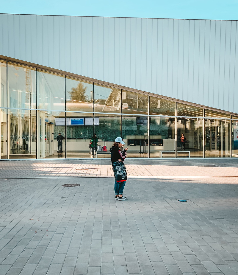 glass - material, woman, city, street, women, aquatic centre, town, daytime, town square, canada, rear view, downtown, built structure, standing, university endowment lands