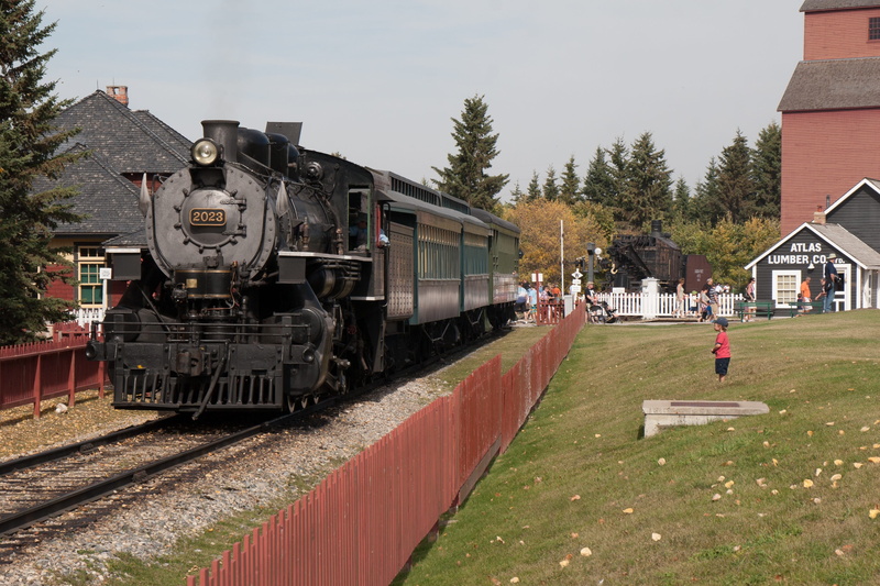transportation, architecture, railroad track, tree, sky, train - vehicle, motion, plant, railway, child, train, rail transportation, station, incidental people