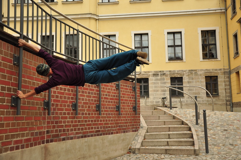 gray, architecture, casual clothing, skill, acrobatics, building exterior, 4K, metal, real people, concrete, flag, built structure, parkour, pole, acrobat