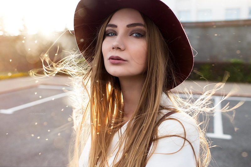 hairstyle, looking at camera, hat, hair, street, face, one person, lifestyles, model, women with hats, beautiful woman, jacket, long hair, headshot, portrait