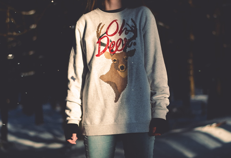 casual clothing, trees, three quarter length, graphic, obscured face, one person, deer, focus on foreground, representation, holding, standing, lifestyles