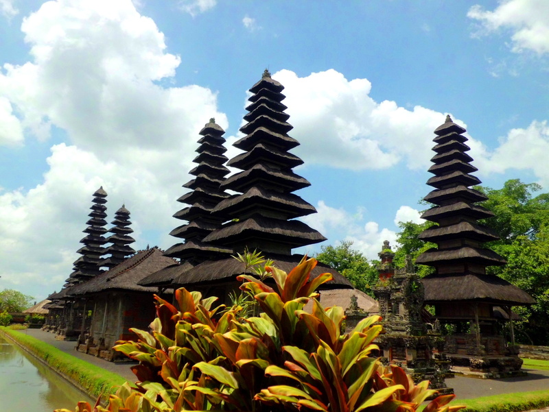 belief, building exterior, no people, plant, leafed, cloud - sky, surrounded, building, green, indonesia, brown, hindu, spirituality, beauty in nature