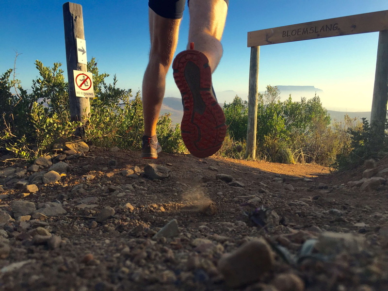 run, human body part, cape town, sky, outdoors, real people, trail running, one person, limb, dirt, table mountain, shorts, human leg, men, human foot