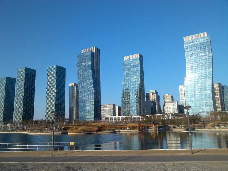building, modern, skyscraper, songdo, outdoors, no people, city life, office building exterior, incheon songdo new city, landscape, clear sky, water, sky