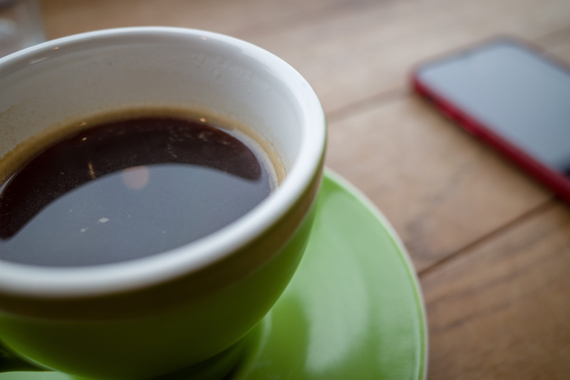 focus on foreground, pottery, hot chocolate, milk, tea, table, tea cup, saucer, drink, potted plant, coffee, coffee cup, porcelain, indoors, mug, hot drink
