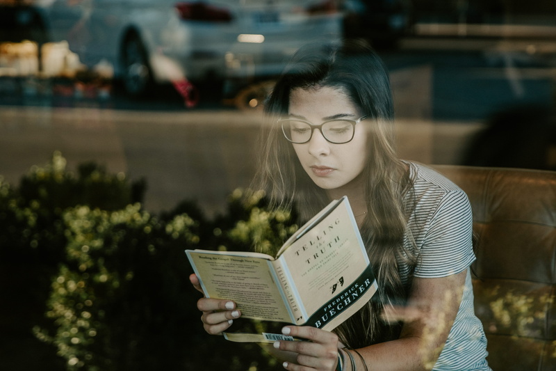 young women, long hair, reading, transportation, leisure activity, people, jar, black, bush, vehicle, holding, headshot, woman, hairstyle, portrait, plant
