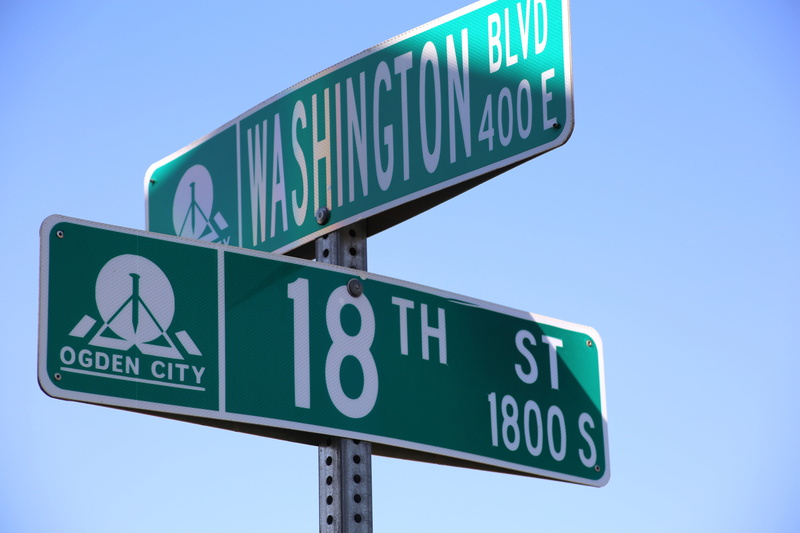 road sign, street, direction, street name sign, sky, green, guidance, directional sign, road, multiple lane highway, communication, travel, transportation