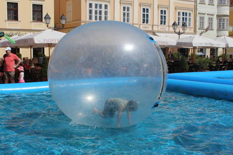 water, building exterior, incidental people, festival, inflatable, attraction, 1080P, kid, sphere, people, outdoors, men, reflection, summer, built structure