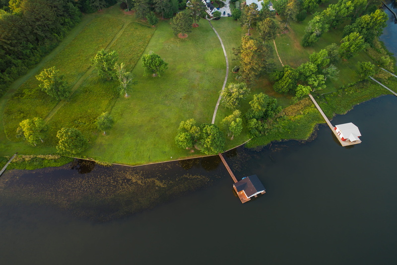 near island, drone view, non-urban scene, lake, no people, day, houses, outdoors, tranquility, nautical Vessel, high angle view, aerial, green, men, near
