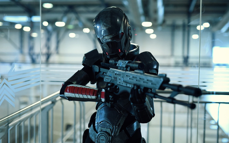 n7 shadow, screenshot, costumes, person, cosplay, one person, illuminated, movie, holding, 1080P, uniform, government, real people, indoors, armed forces