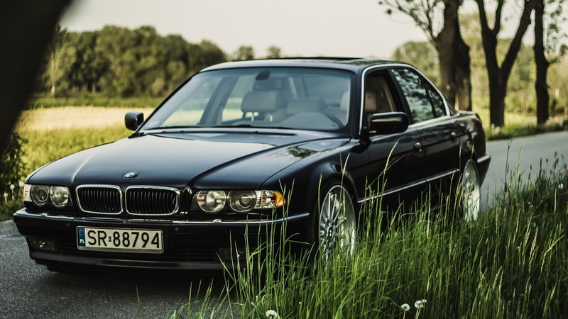 black, motor vehicle, nature, selective focus, grass, plant, no people, car, silver colored, BMW, stationary, close-up, tree, day, sedan, green color, focus on foreground