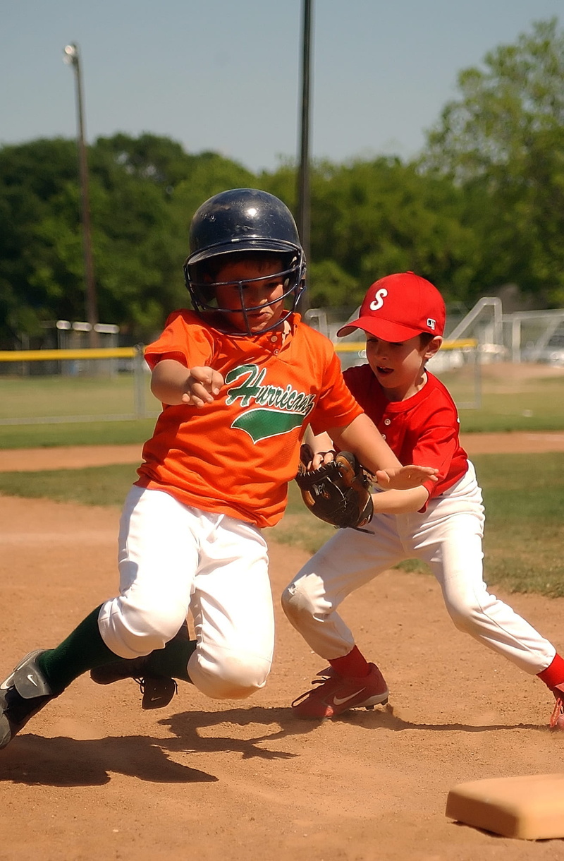 athlete, child, evasive, diamond, ballpark, sports helmet, competition, fun, full length, game, infield, team, lifestyles, action, men, boy, tag, dirt