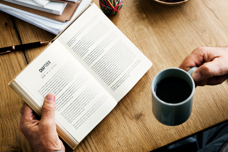 chapters, school, people, human body part, knowledge, table, indoors, publication, wood - material, one person, drink, 5K, man, business, hand, one man only