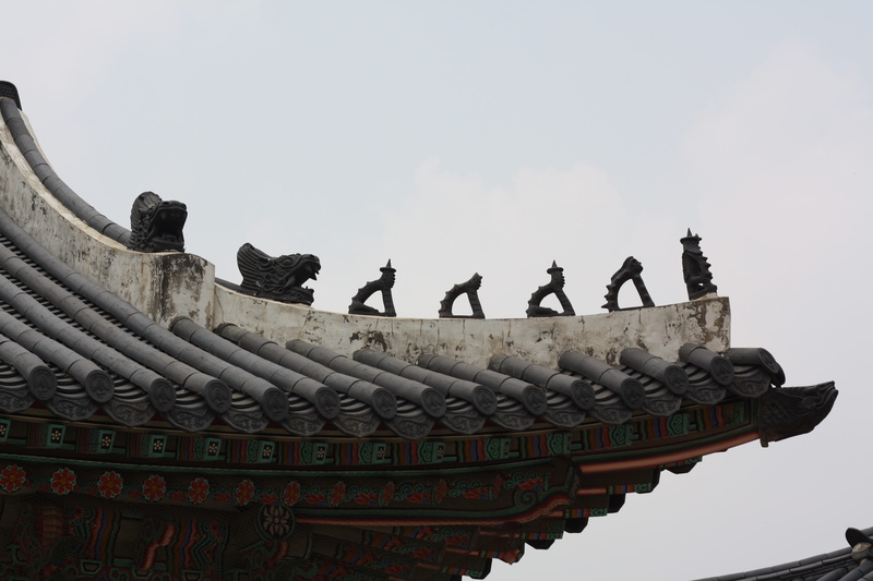 gyeongbok palace, glyph, art and craft, representation, traditional, low angle view, place of worship, outdoors, ancient, Roof, city, temple - Building