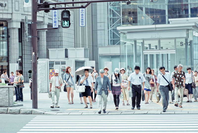 sidewalk, sign, street, women, men, adult, architecture, striped, man, street sign, crowd, umbrella, pedestrian, city, built structure, real people, near