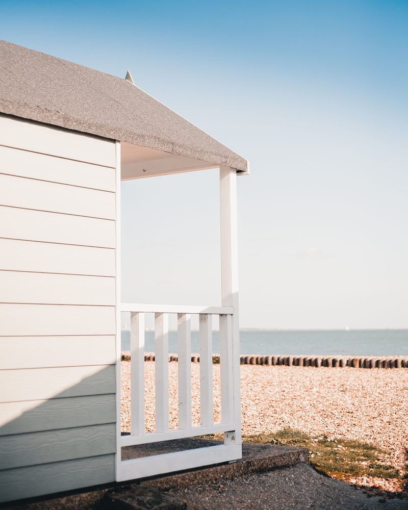 sunny, building exterior, horizon over water, land, beach, plant, white, day, yard, railing, architecture, housing, porch, sunlight, shelter, nature, clear sky