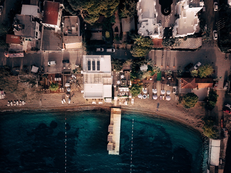 seafront, no people, plant, blue, pier, water, photography, umbrella, building, near, building exterior, nature, drone view, waterfront, built structure