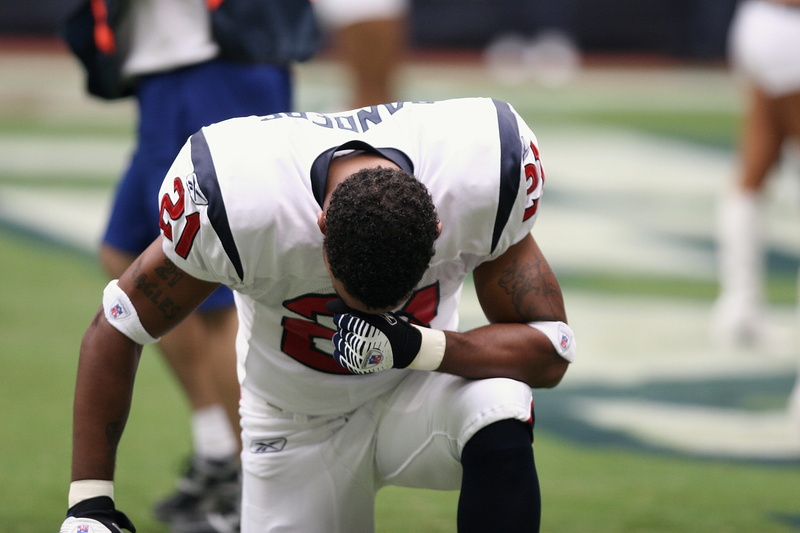 day, person, prayer, american football - ball, sports uniform, stadium, sportsman, clothing, football player, standing, adult, team sport, footballer, young adult