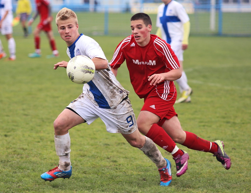 soccer ball, team, soccer uniform, men, motion, sports equipment, grass, two people, soccer, athlete, teamwork, people, sports uniform, running, young adult