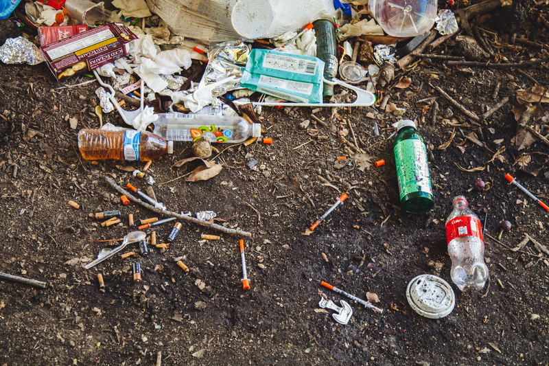 drugs, high angle view, outdoors, hydrant, streets, environmental damage, communication, dirt, fire hydrant, wheel, beverage, nature, homeless, pollution