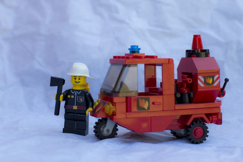 red, piaggio ape, snow, toy car, land vehicle, helmet, 5K, white color, no people, vvf, transportation, firefighters, nature, day, motor vehicle, firemen
