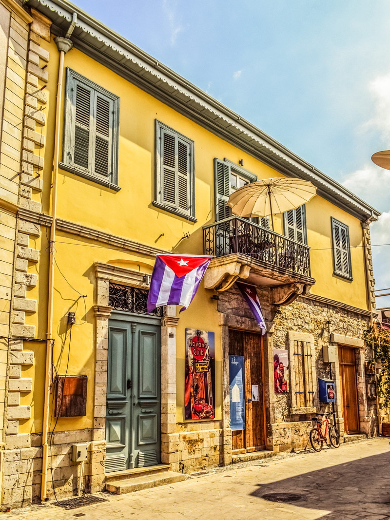 flag, no people, clothing, built structure, sky, building exterior, hanging, yellow, havana club, old town, city, cyprus, laundry, building, drying, outdoors