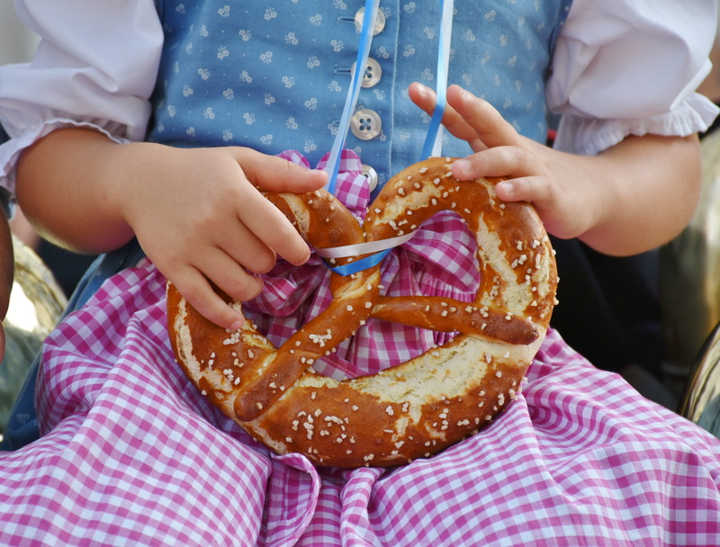 front view, finger, temptation, clothing, focus on foreground, women, costume, 4K, breze, dirndl dress, human body part, salty, baked goods, pretzels