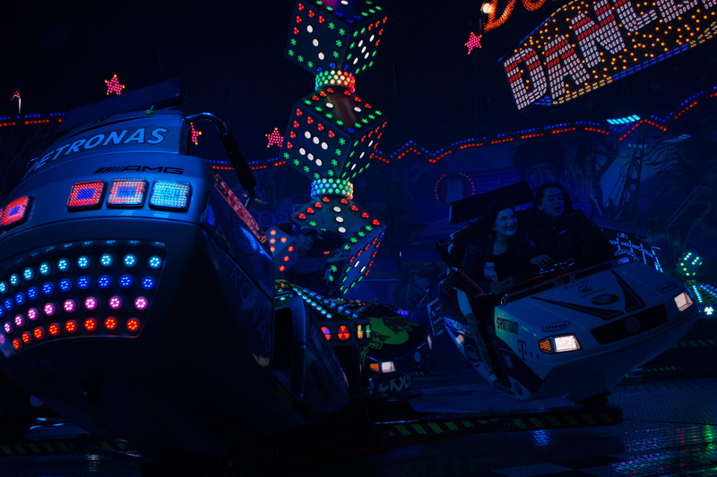 neon light, mode of transportation, attraction, toy, technology, land vehicle, illuminated ride, vehicle, nightlife, tech, amusement park, colors, ride