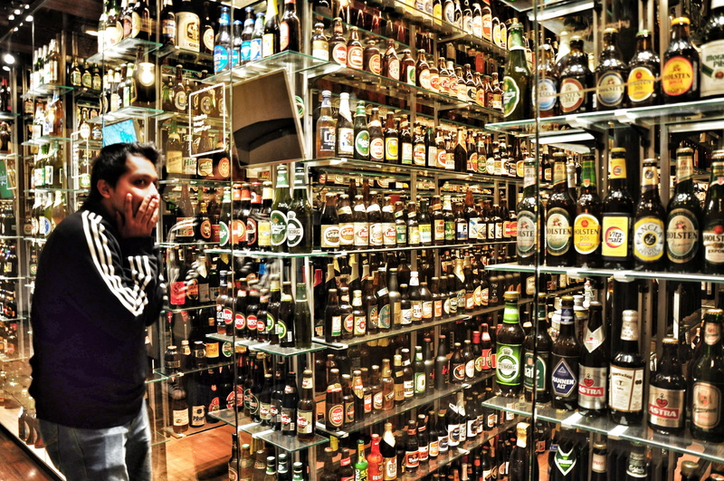refreshment, pub, wine, large group of objects, bottle, choice, refreshing, illuminated, container, wine bottle, adult, standing, cold, indoors, liquor store