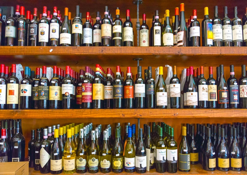 large group of objects, lot, indoors, arrangement, bar counter, bar - drink establishment, wine, no people, wines, container, in a row, abundance, food and drink
