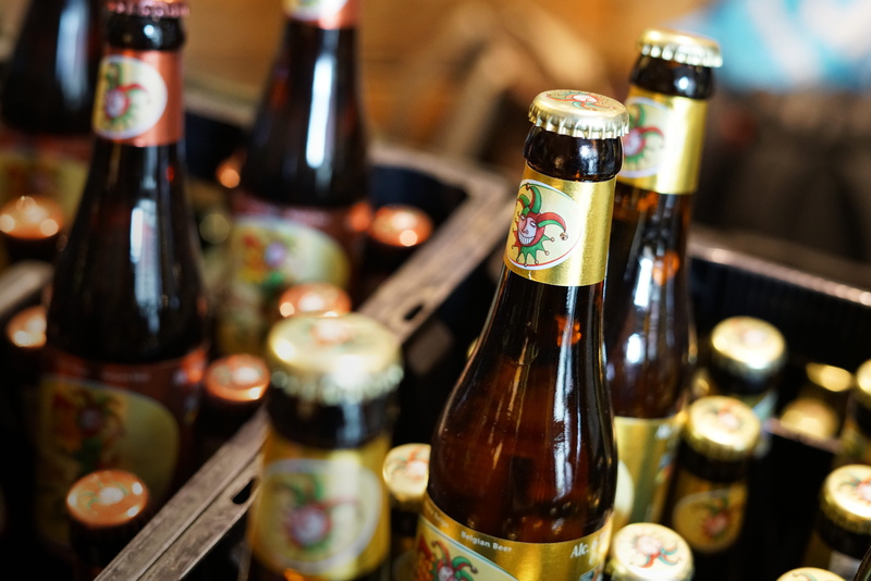 bottle top, joker, crate, belgian beer, no people, container, focus on foreground, bruges, luxury, glass, alcohol, food and drink, beer, brugge, still life