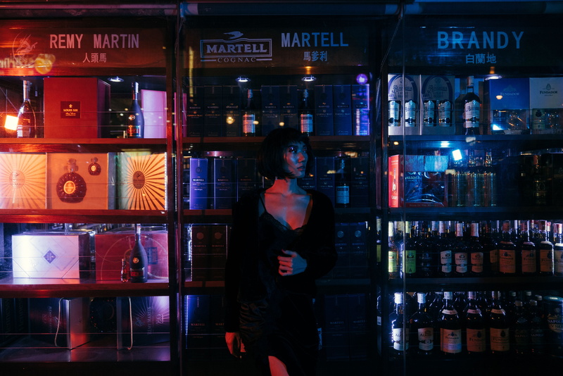 bottle, liquor, lifestyles, city, standing, food and drink, street, neon, sony, art, shelf, store, communication, mirrorless, model, fashion, real people
