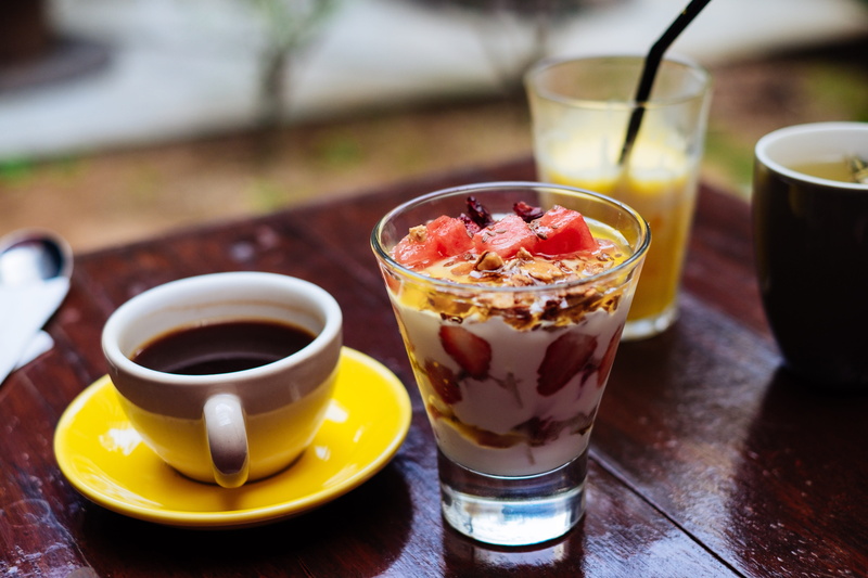ceramic, fruit, spoon, food, glass, mug, restaurant, brown, watermellon, wooden, white, drinking glass, espresso, clear, meal, kitchen utensil, table, serve