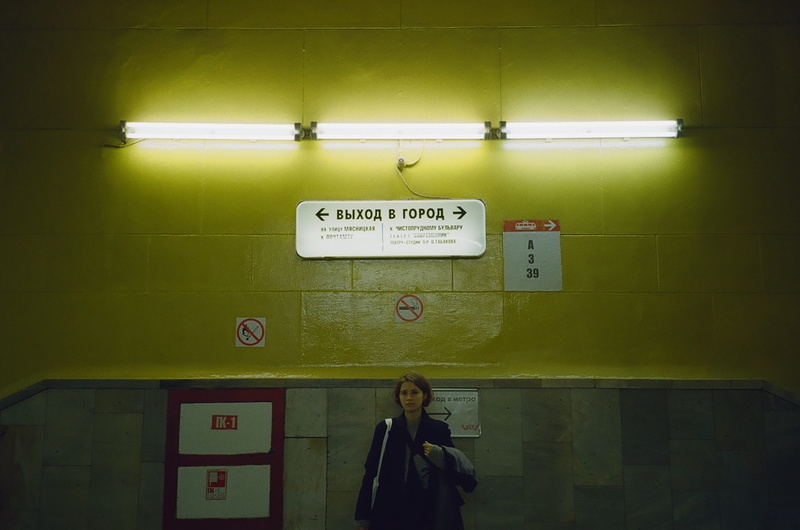 lighting, standing, woman, front view, handrail, lighted, bulb, real people, script, one person, person, communication, subway station, western script