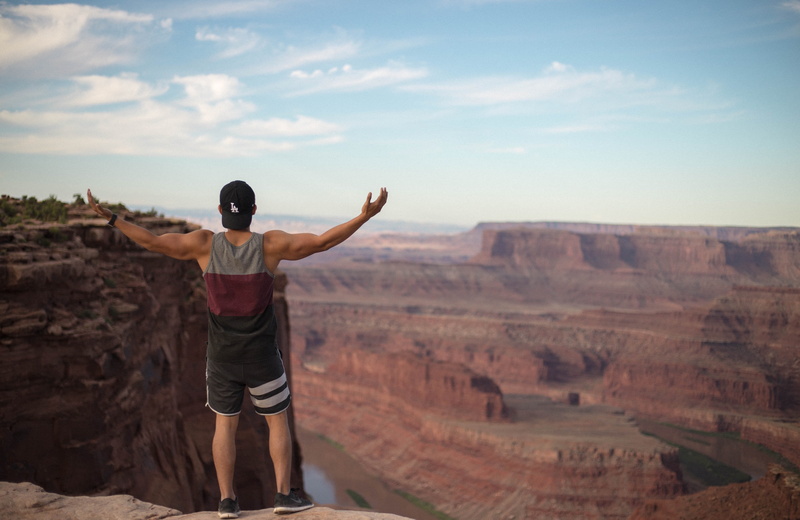 person, arms raised, full length, real people, human, cliff, man, lifestyles, leisure activities, nature, casual clothing, environment, one person, apparel