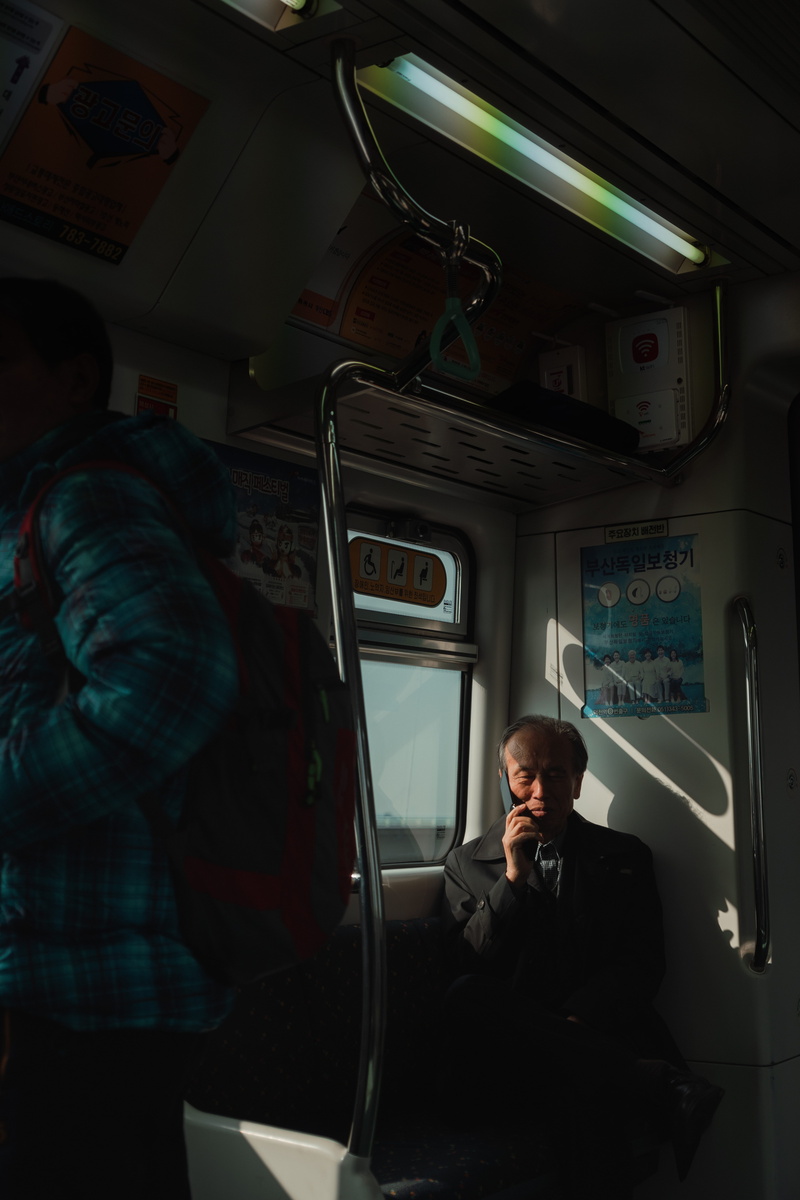 real people, bus, clothing, window, vehicle, 5K, mobile phone, apparel, males, finger, using phone, person, passenger car, travel, human, shelf, train - vehicle