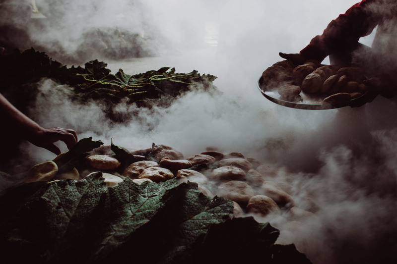 holding, vegetable, body part, steaming, bake, oven, smoke - physical structure, human hand, outdoors, day, human body part, bread, environment, moody